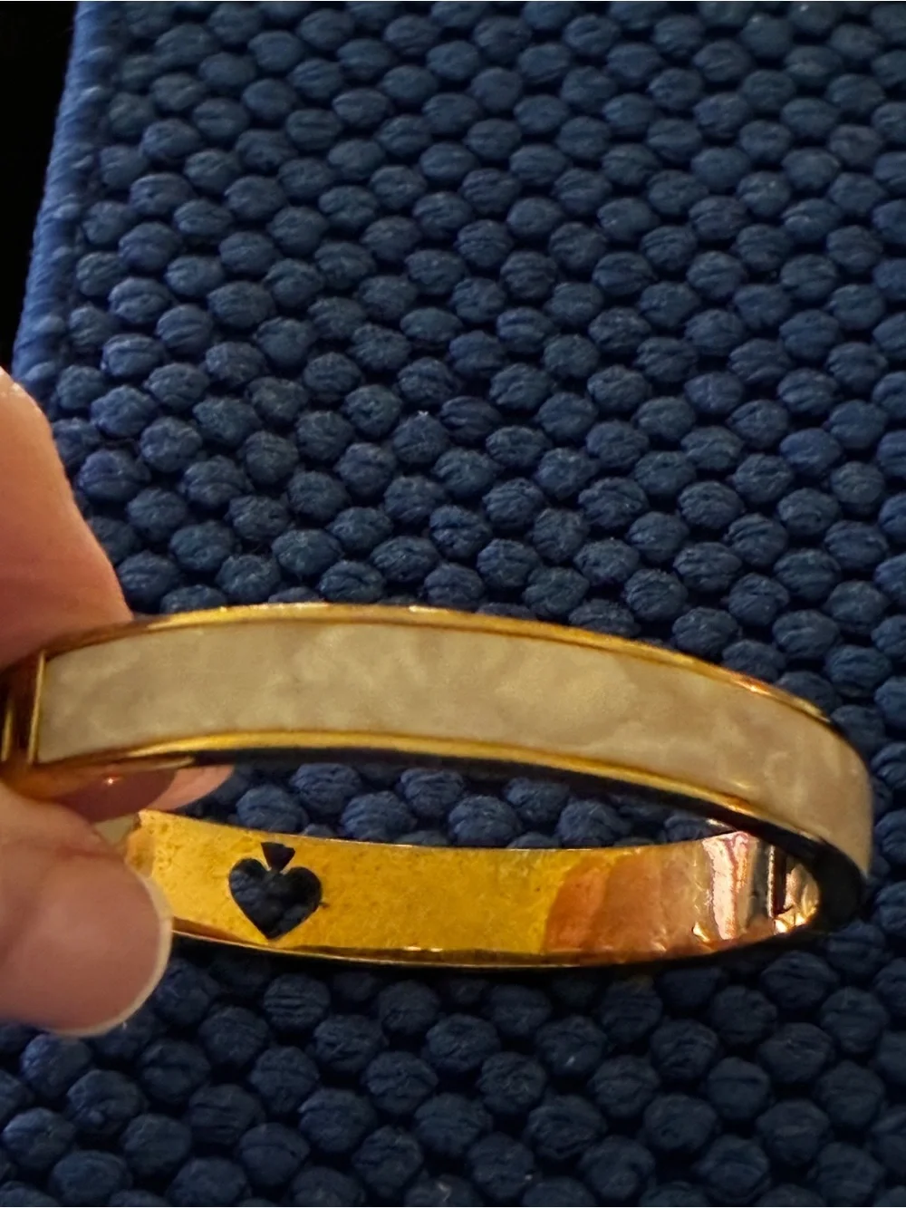 Kate Spade gold-tone bangle with cream enamel and heart detail